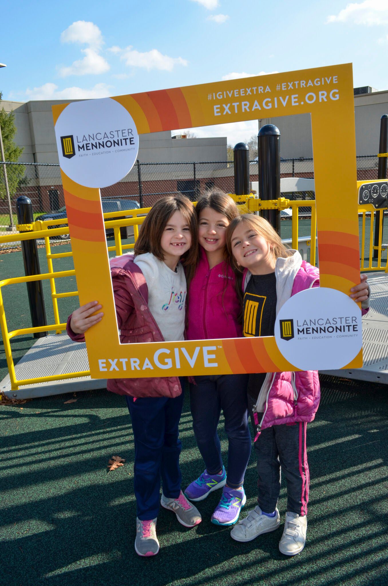 The LM students holding the Extragive Sign