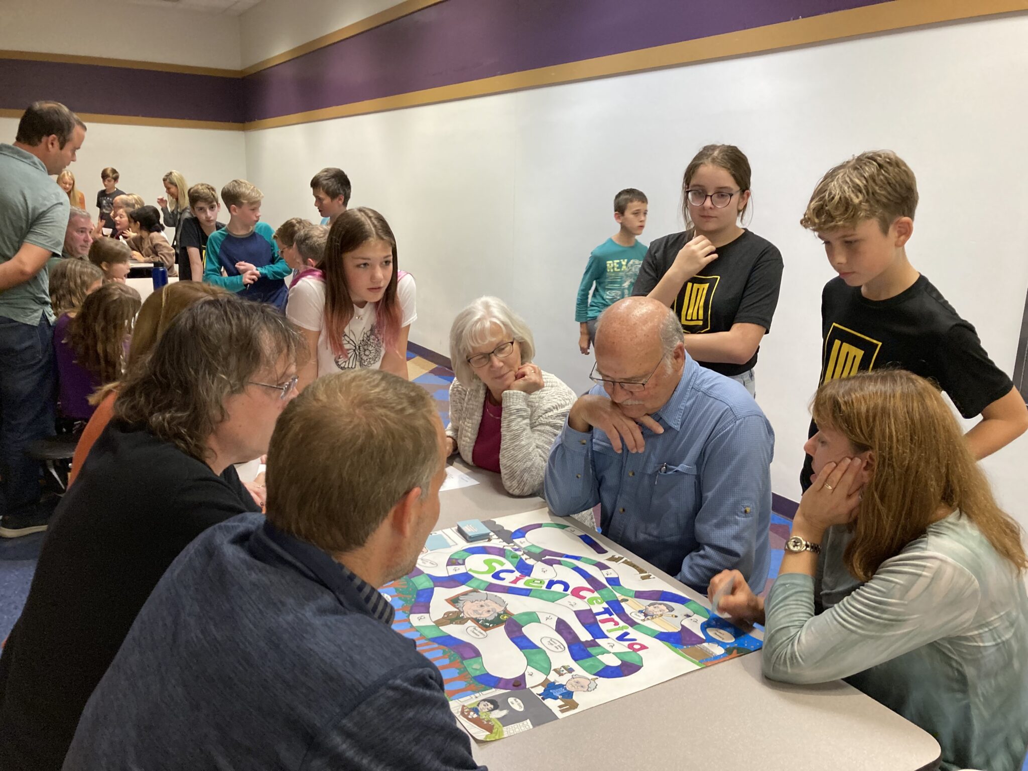 Students and family members playing game