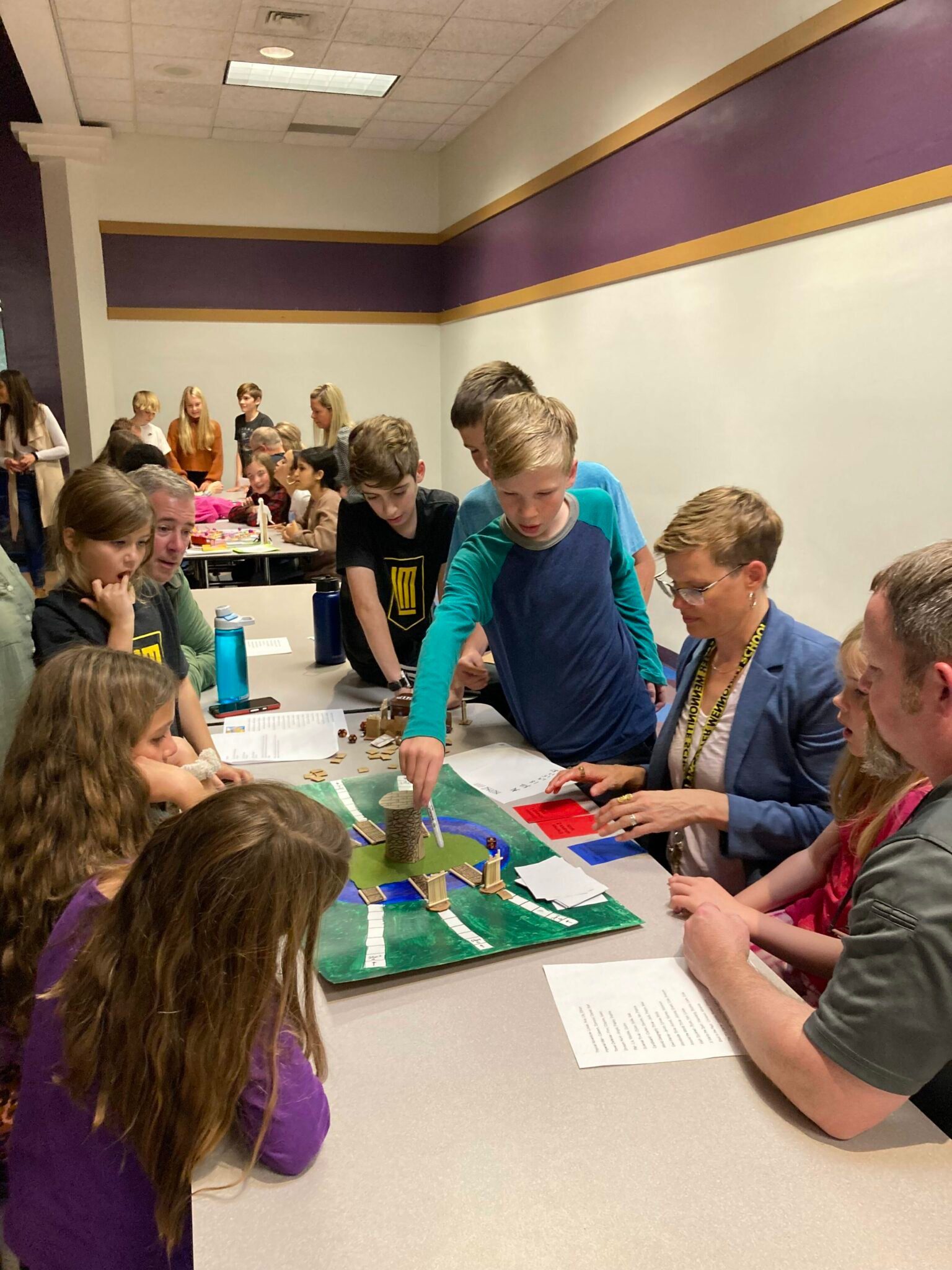 Middle School Students playing games with family members