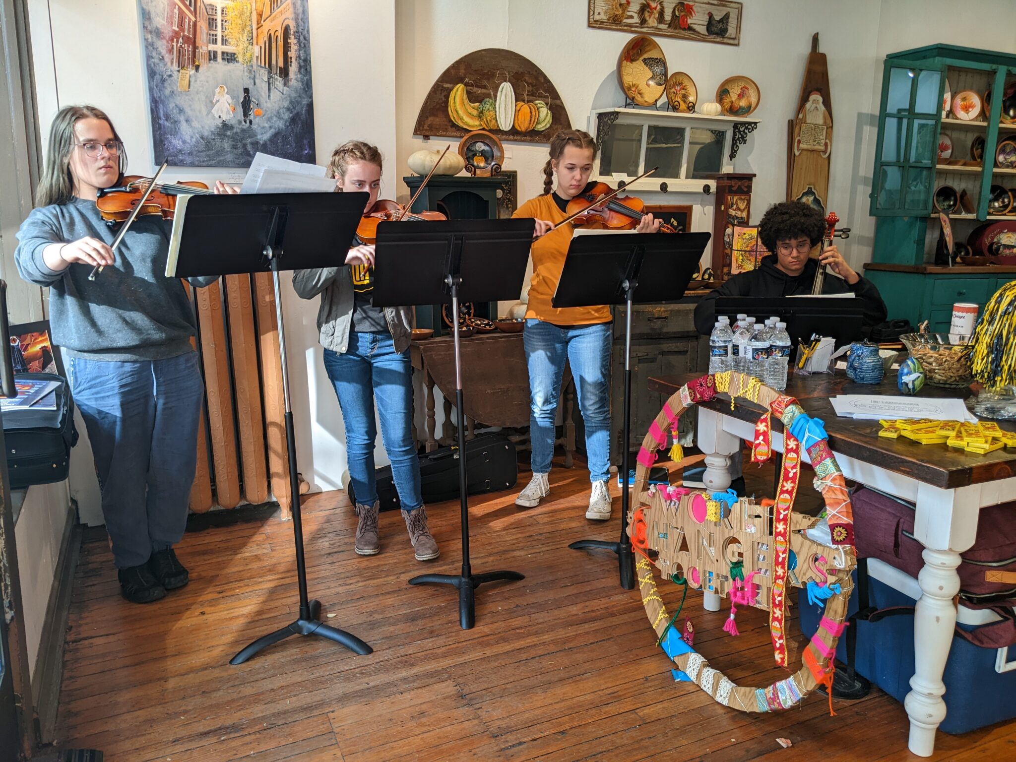 Four students playing instruments