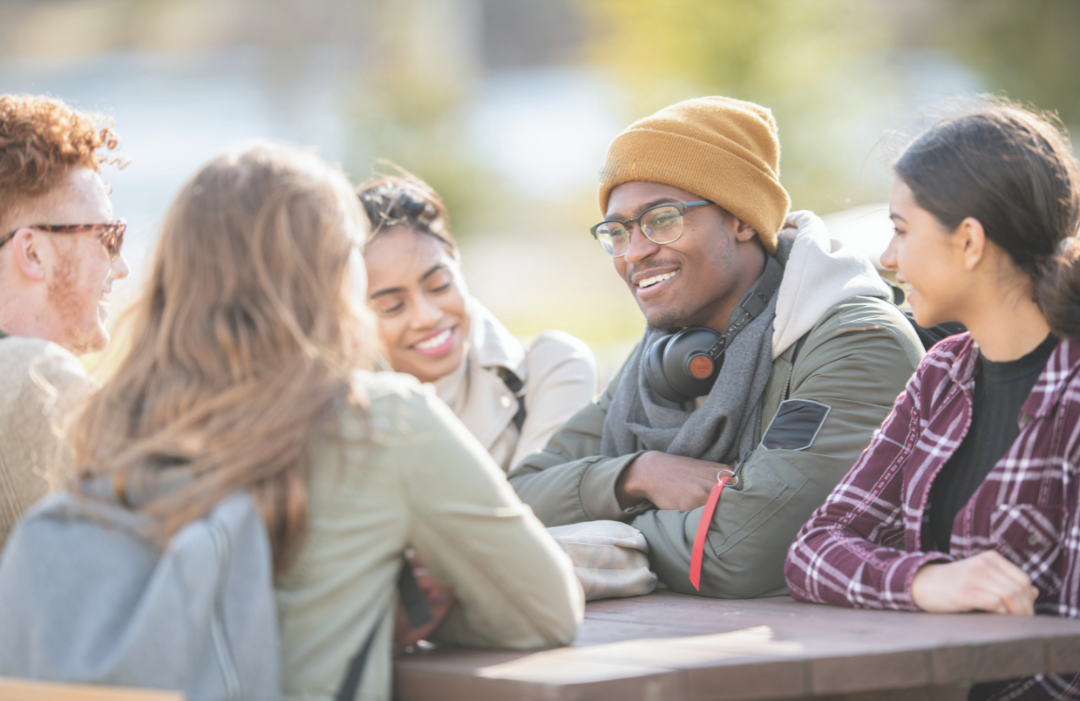 Group of people sitting at table talking