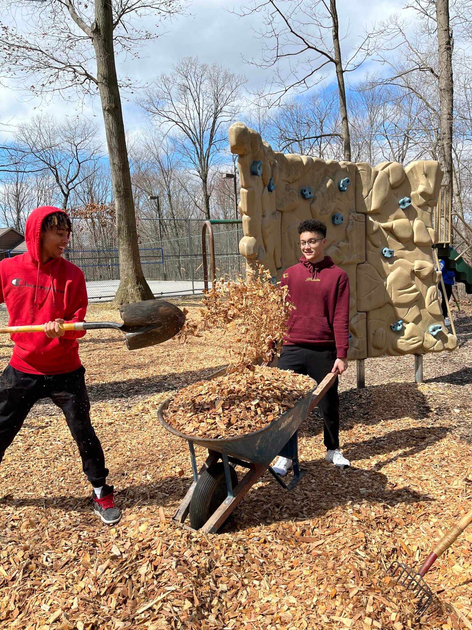 Two LM students cleaning up outside as part of World Changer Week