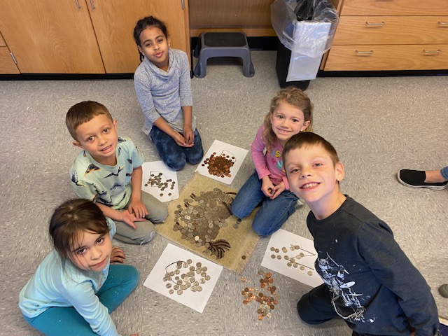 LM elementary students counting coins.