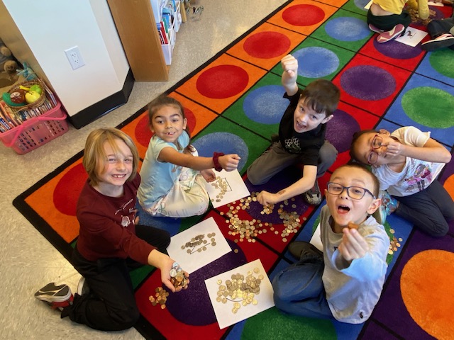 LM elementary students counting coins.