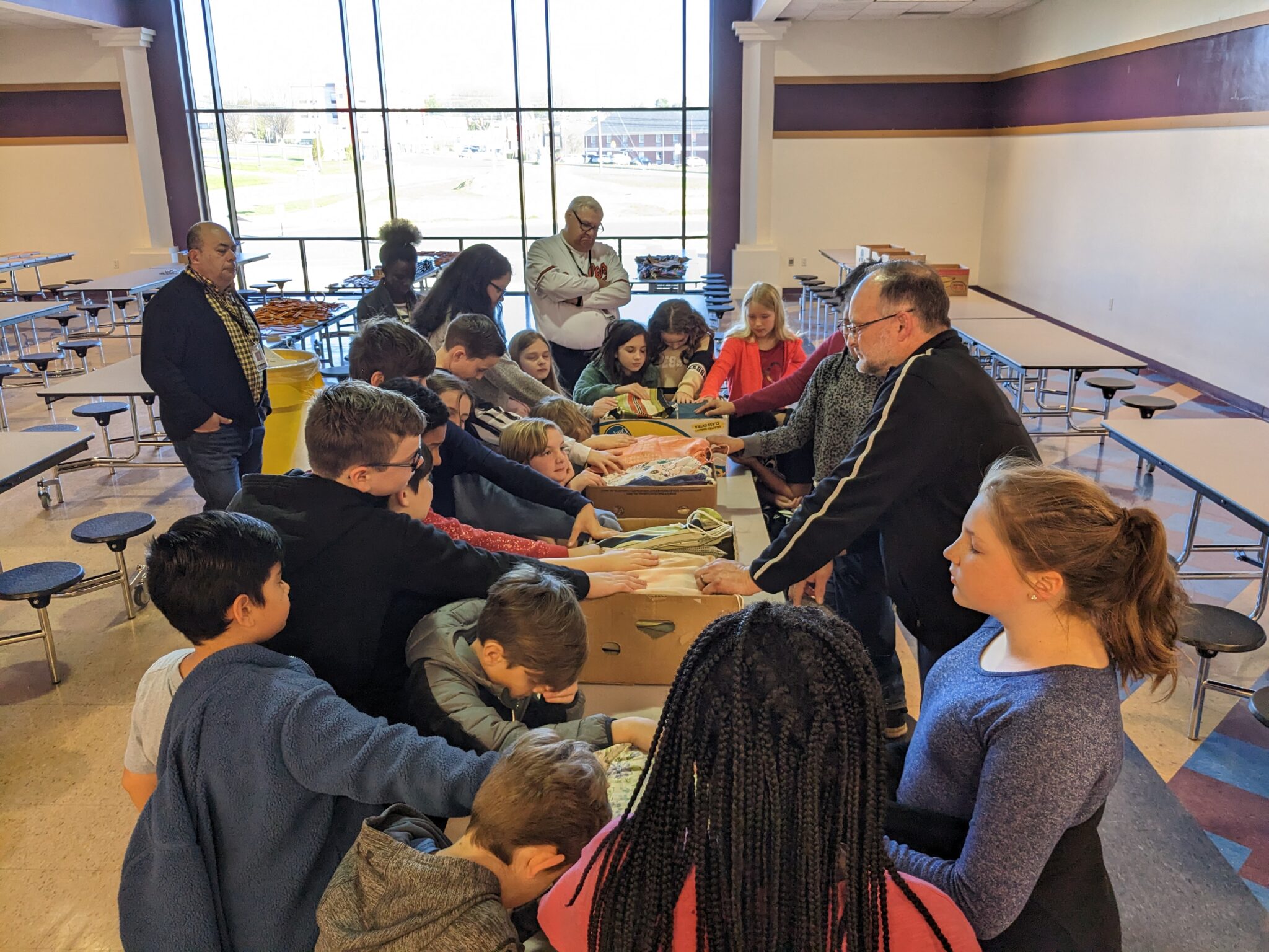 LM high school and elementary students working together to create care packages.