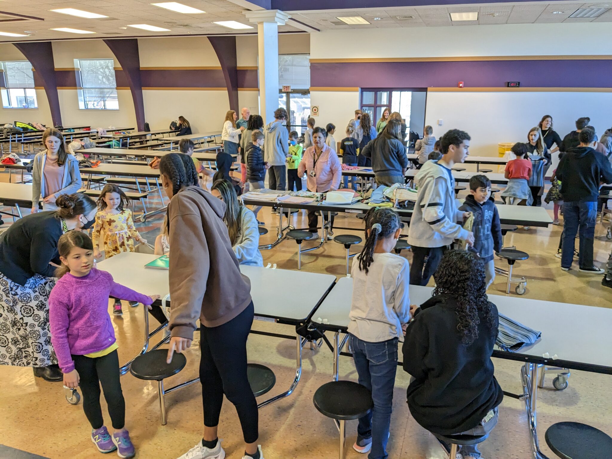 LM high school and elementary students working together to create care packages.