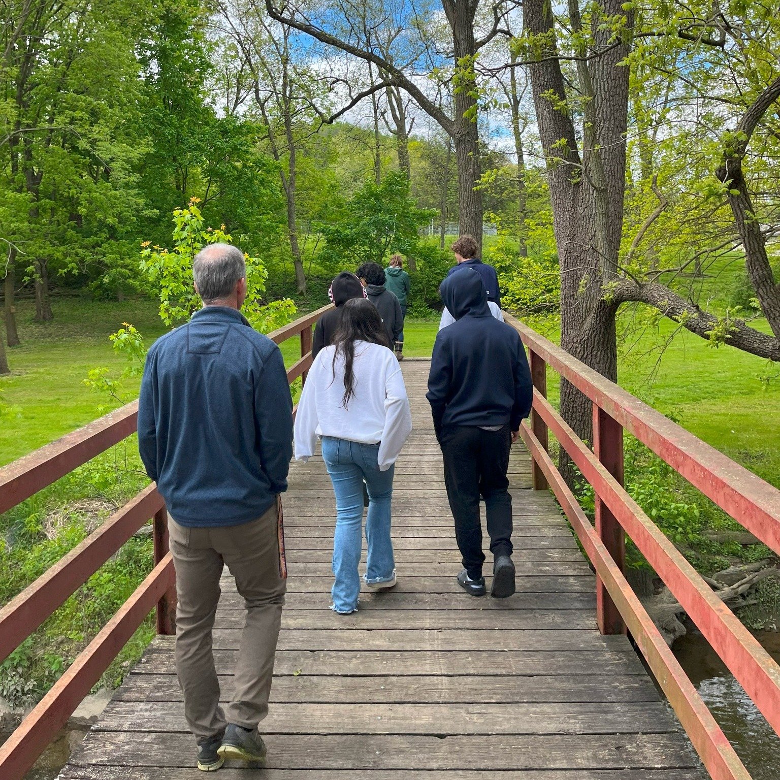 Group of LM students walking over Bridge