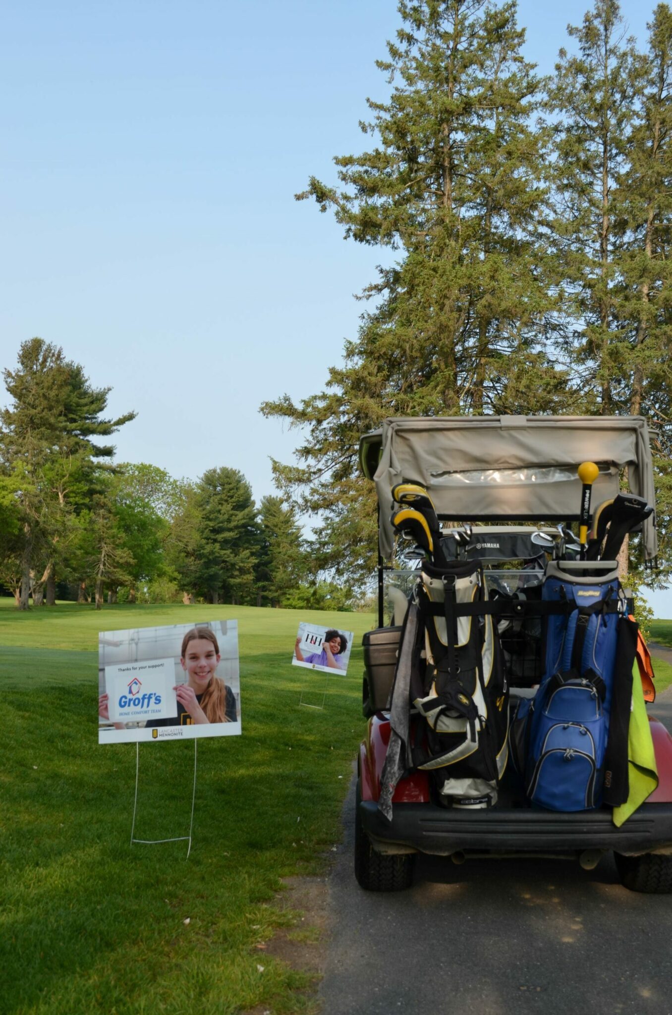 Golf cart and sponsor signs.