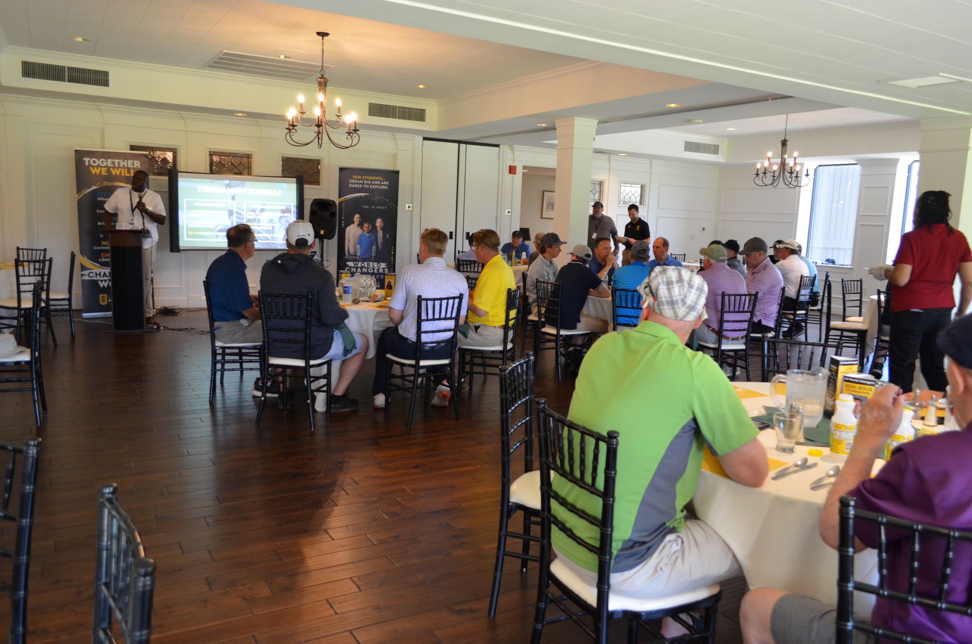 Dr. Badriaki speaking to golfers during presentation.