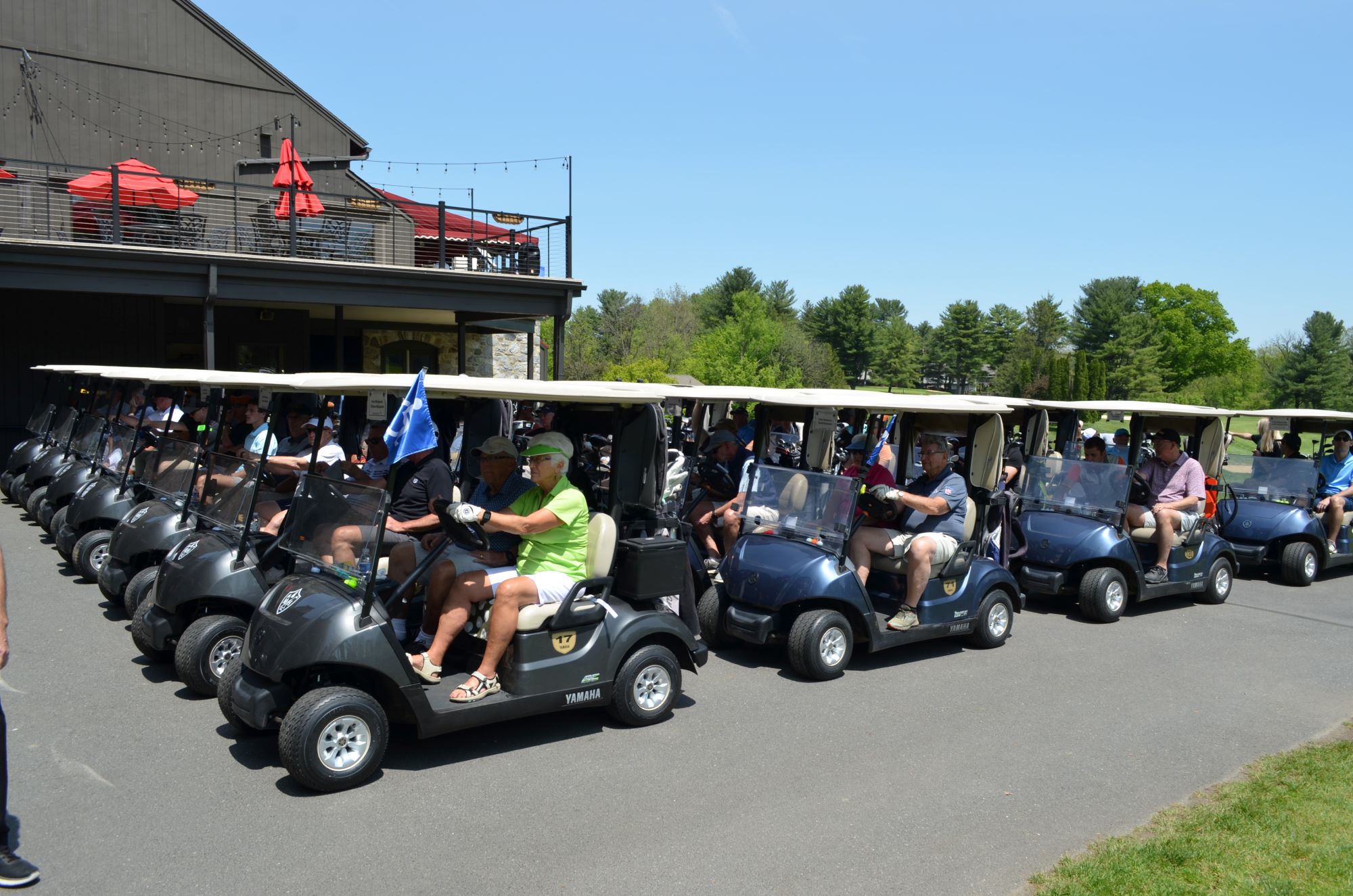 The afternoon round of golfers getting ready to go out in their golf carts.