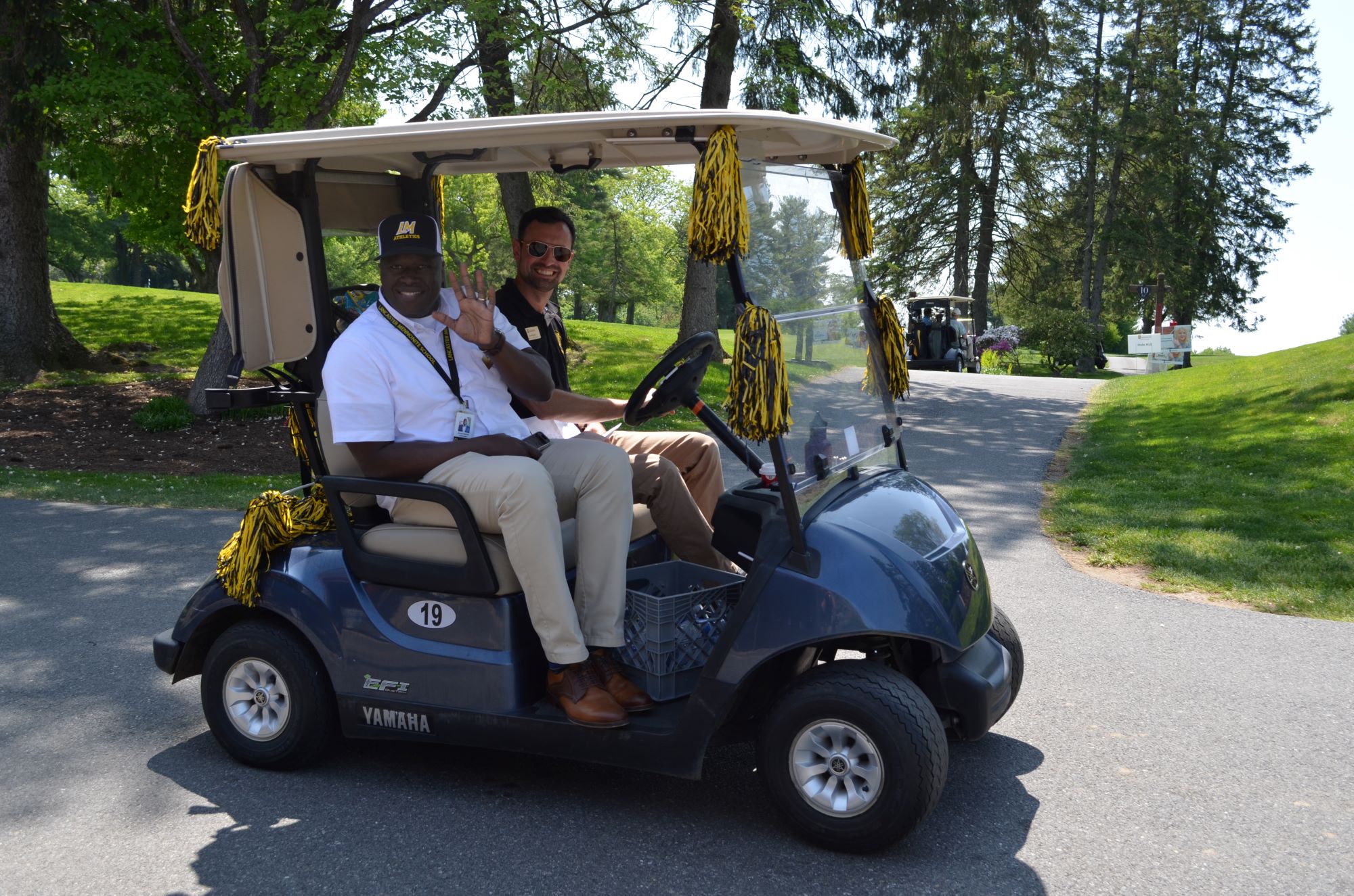 Dr. Badriaki and Jon Heinly on the golf cart.