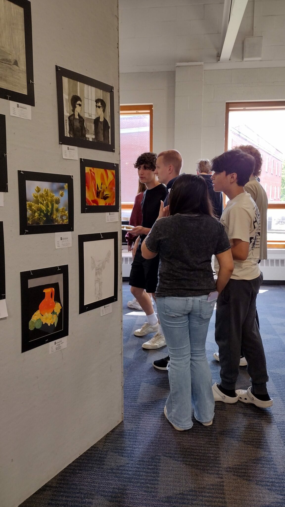 students looking at art display