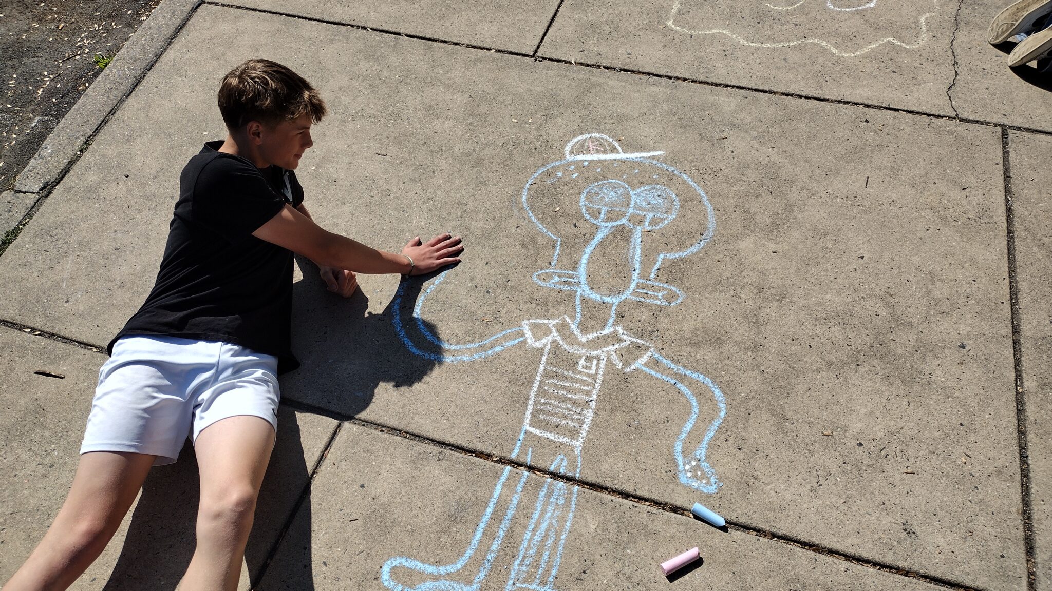 Student drawing on sidewalk