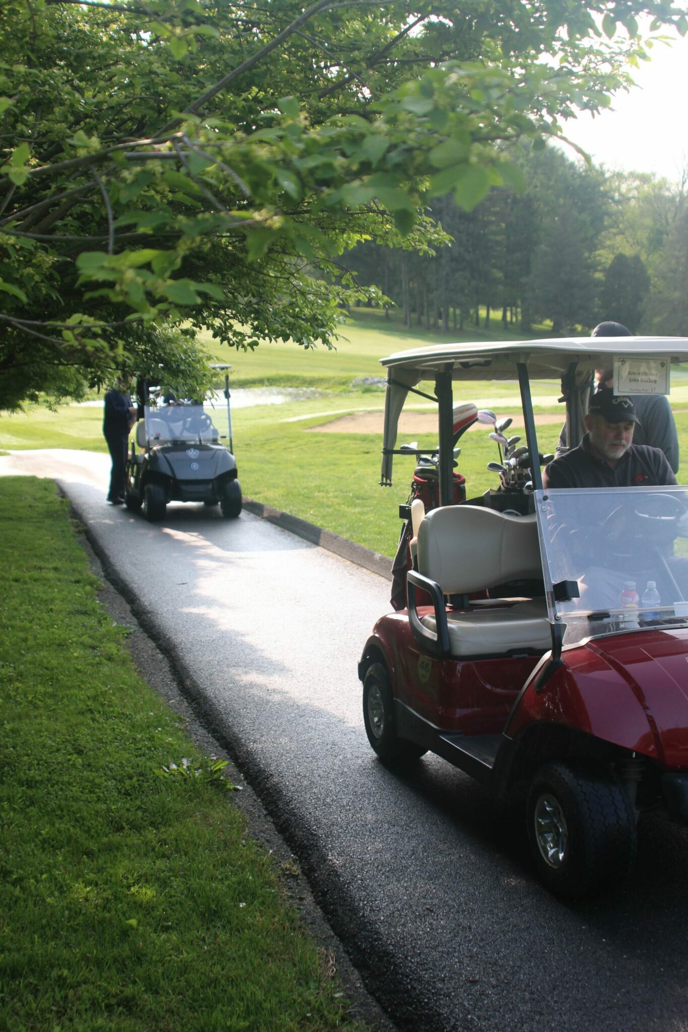 Golfers and golf cart at the Golf Tournament