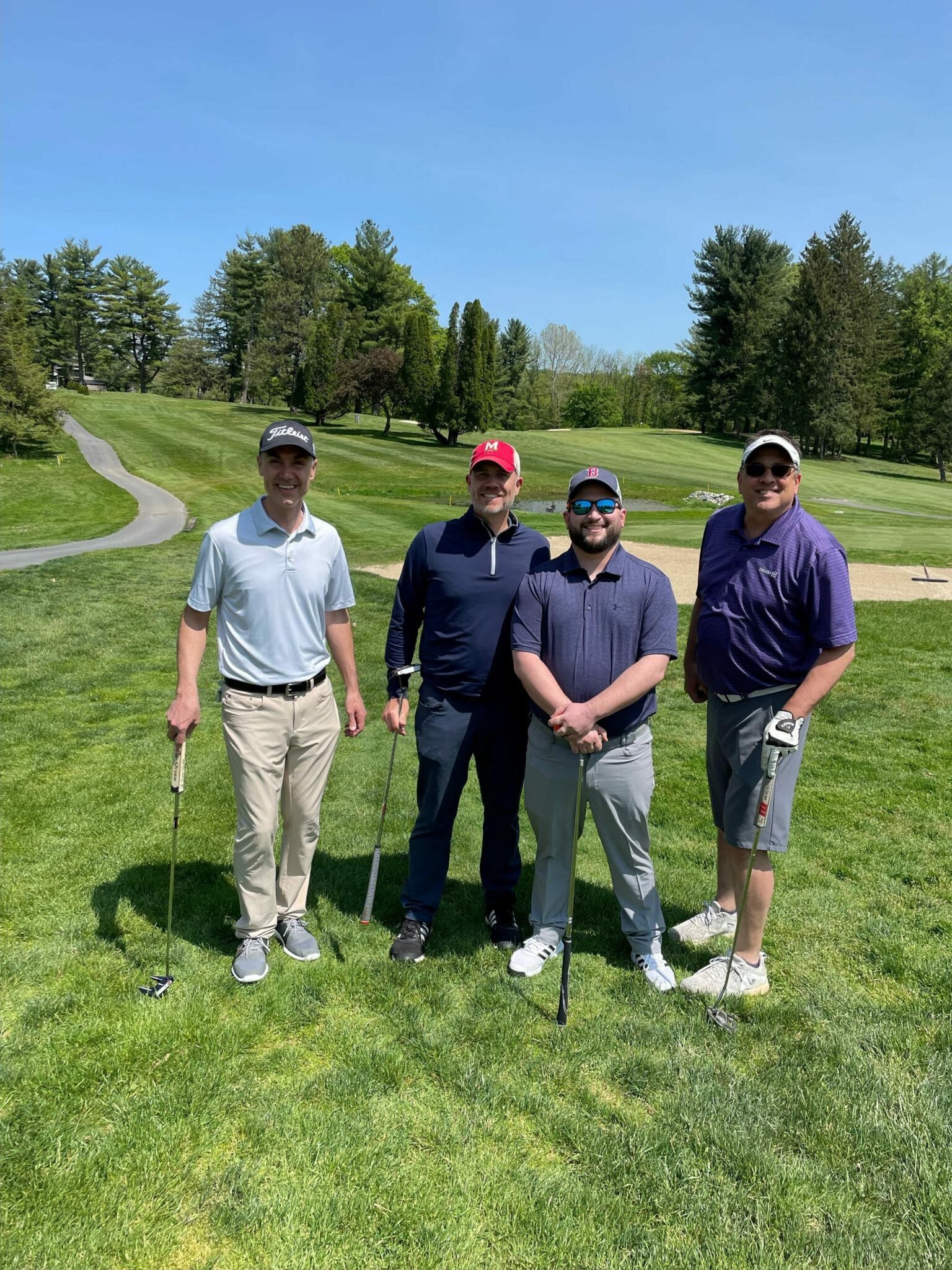 Four golfers on the course.