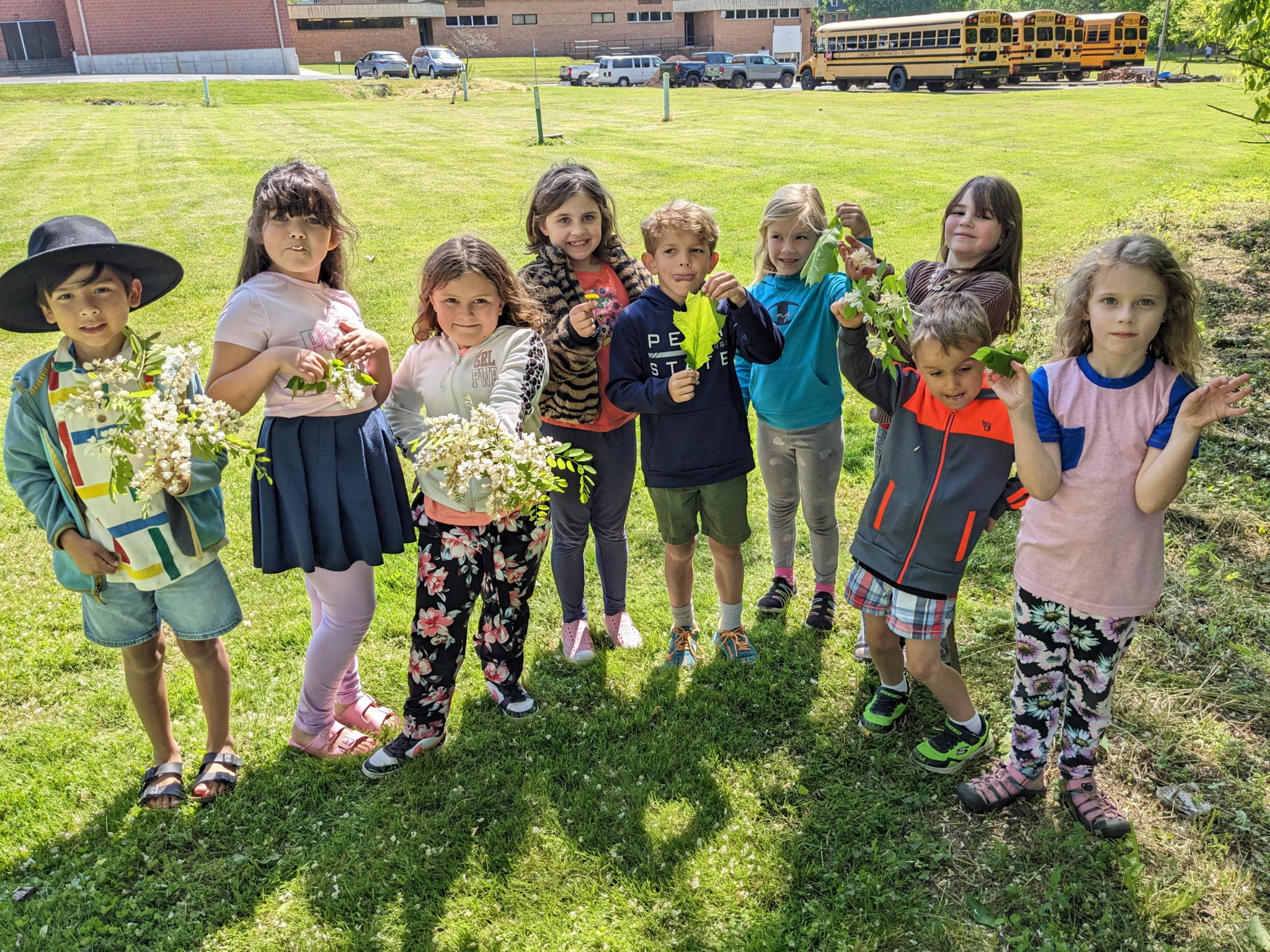 Students displaying leaves they found on nature walk