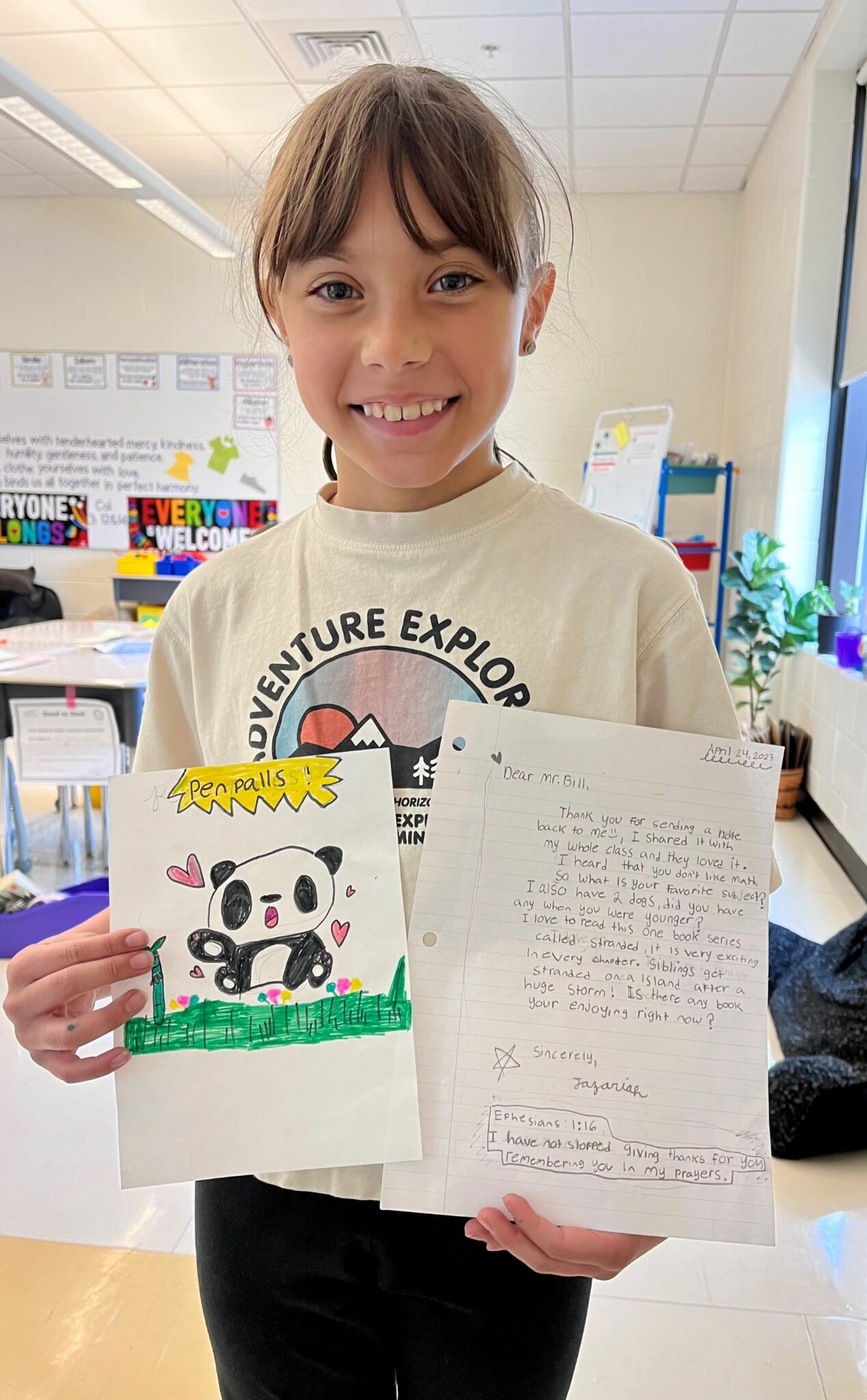 student holding up letter