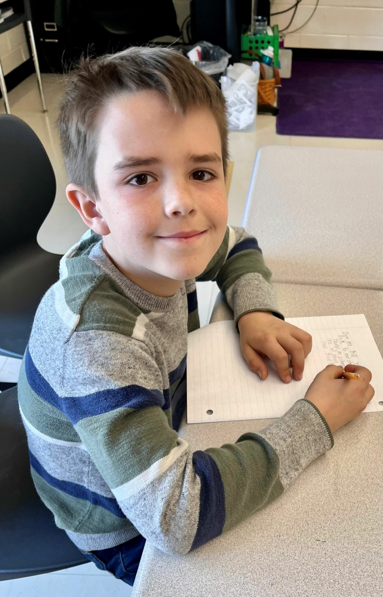 student writing at desk