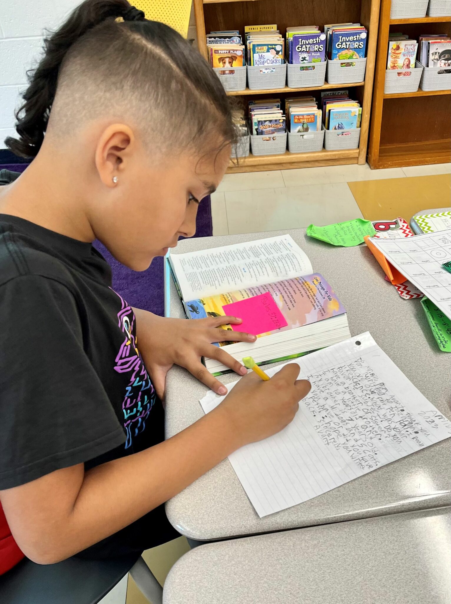 student writing at desk