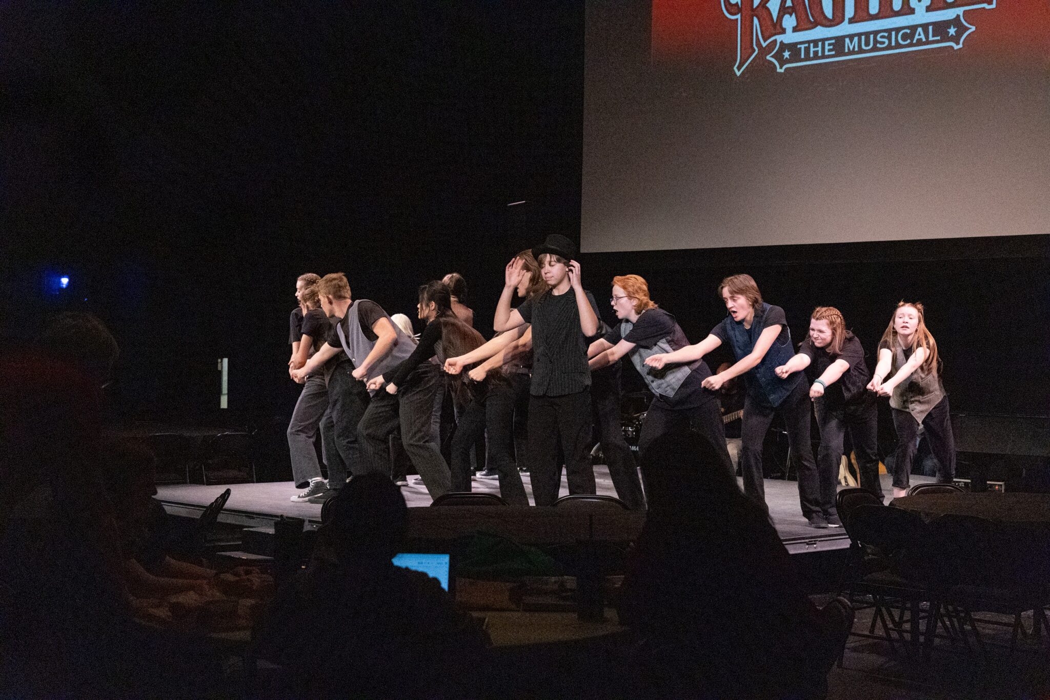 Students singing and dancing on stage