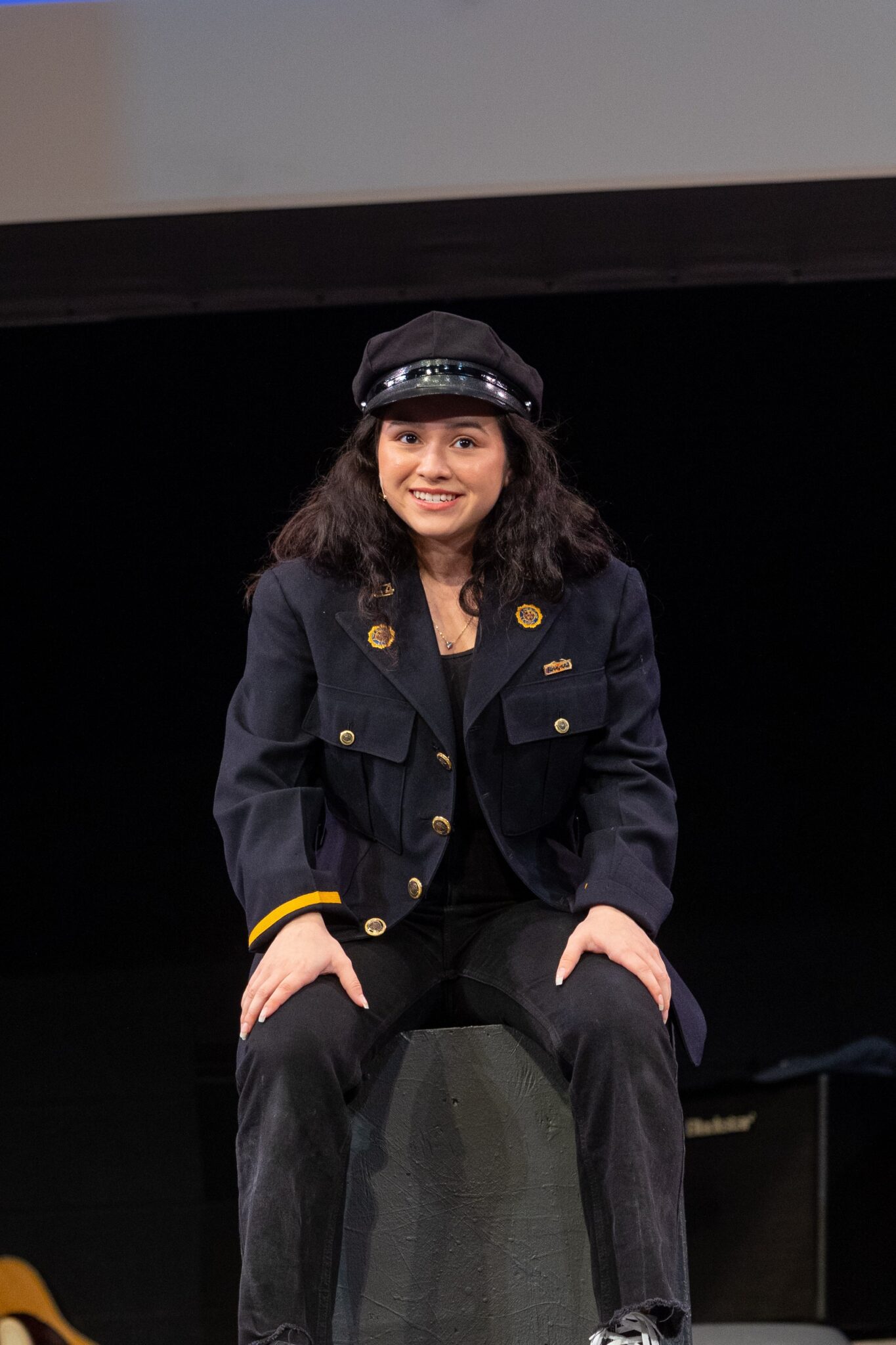LM student on stage sitting