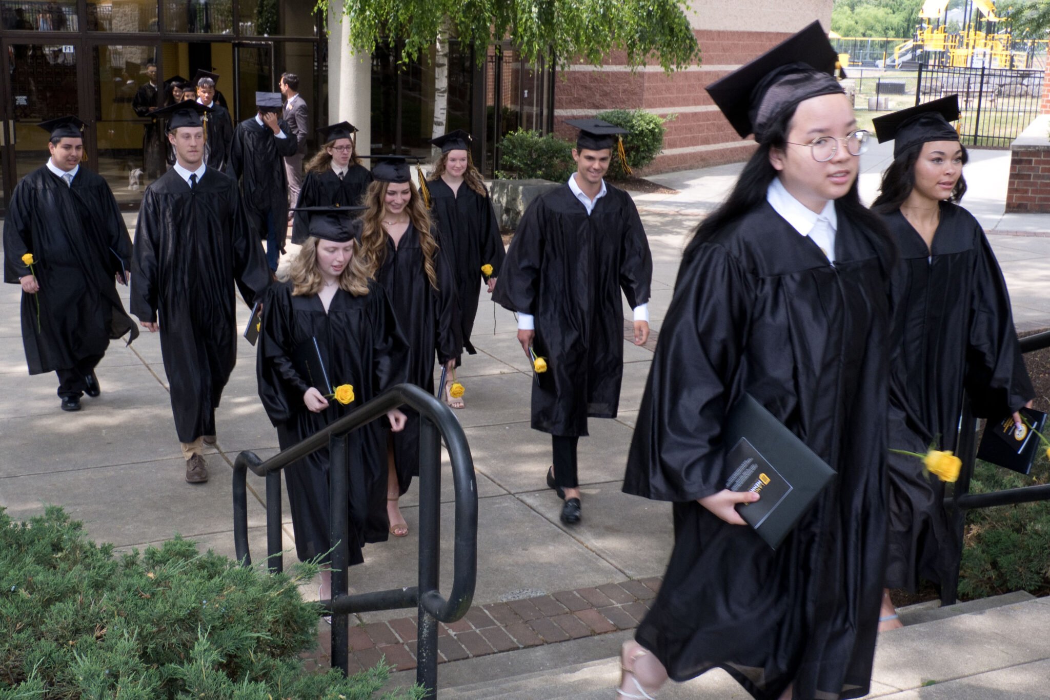 LM students walking out of Fine Arts Center after graduation