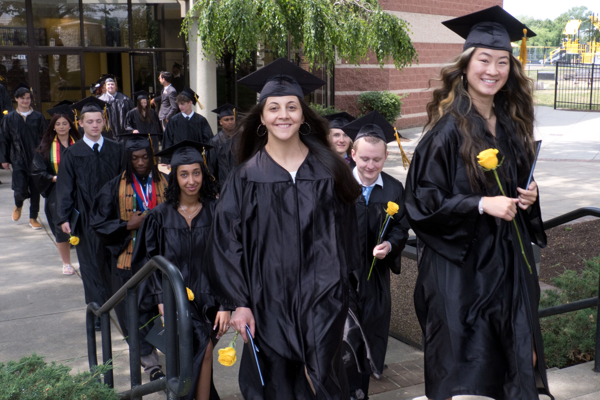 LM students walking out of Fine Arts Center after graduation