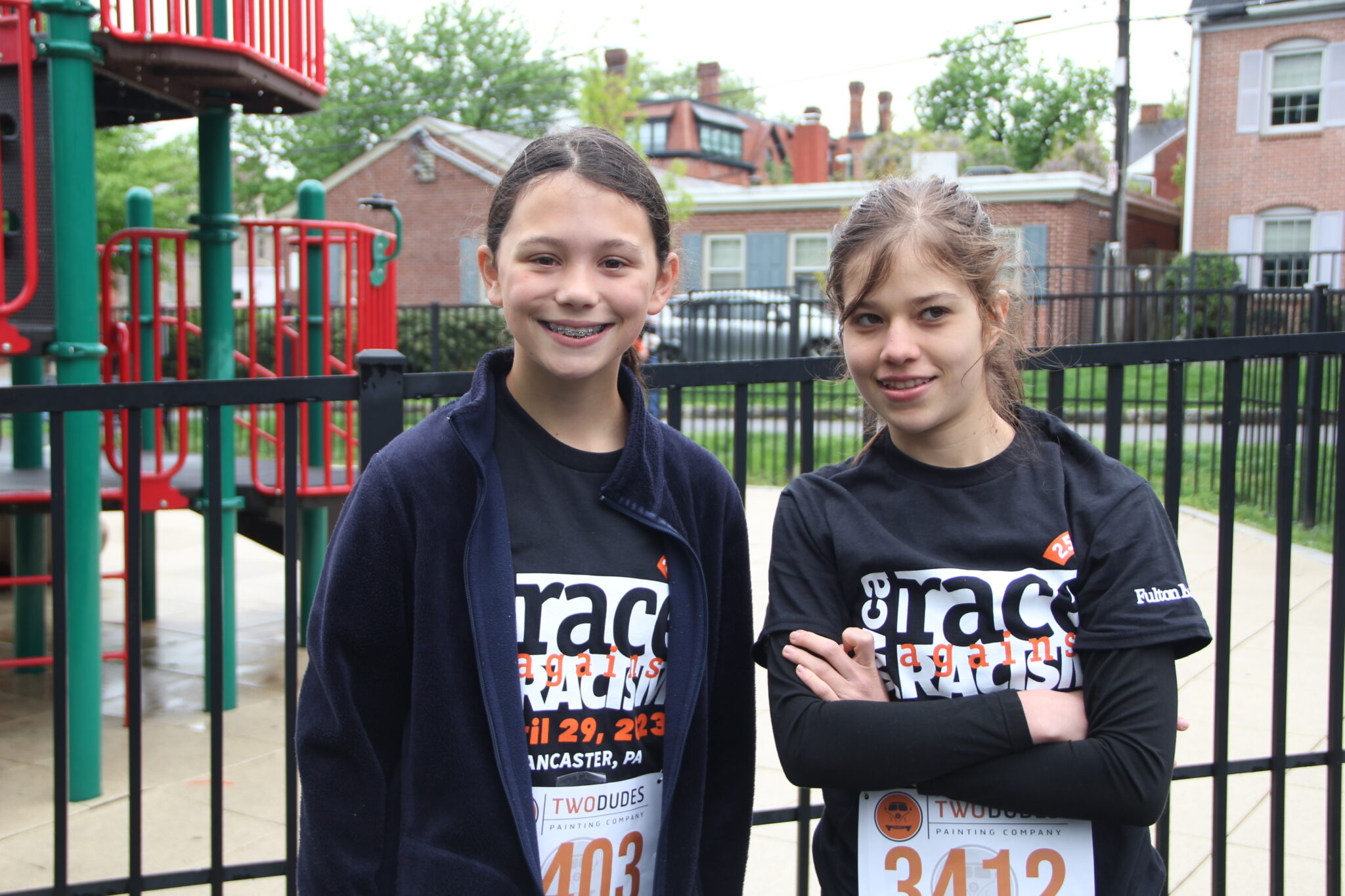 Two students in front of a playground