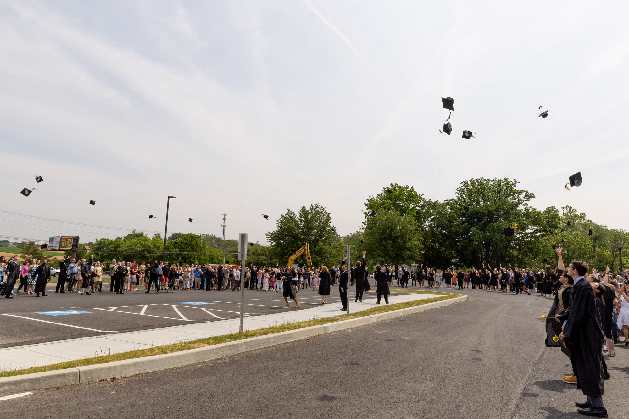 Graduates and family members outfront of school.