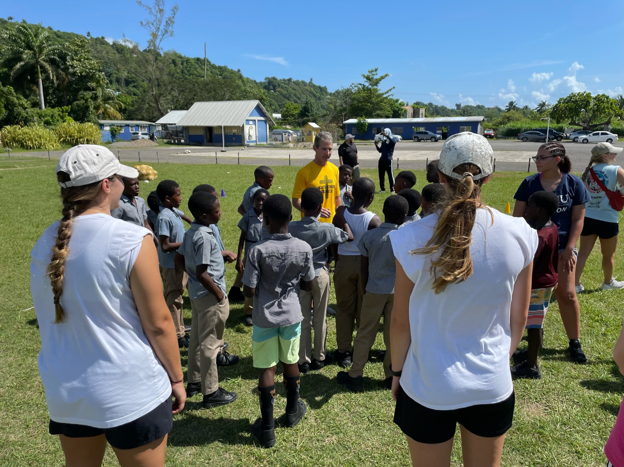 LM Varsity Girls Soccer Team in Jamaica teaching kids how to play soccer