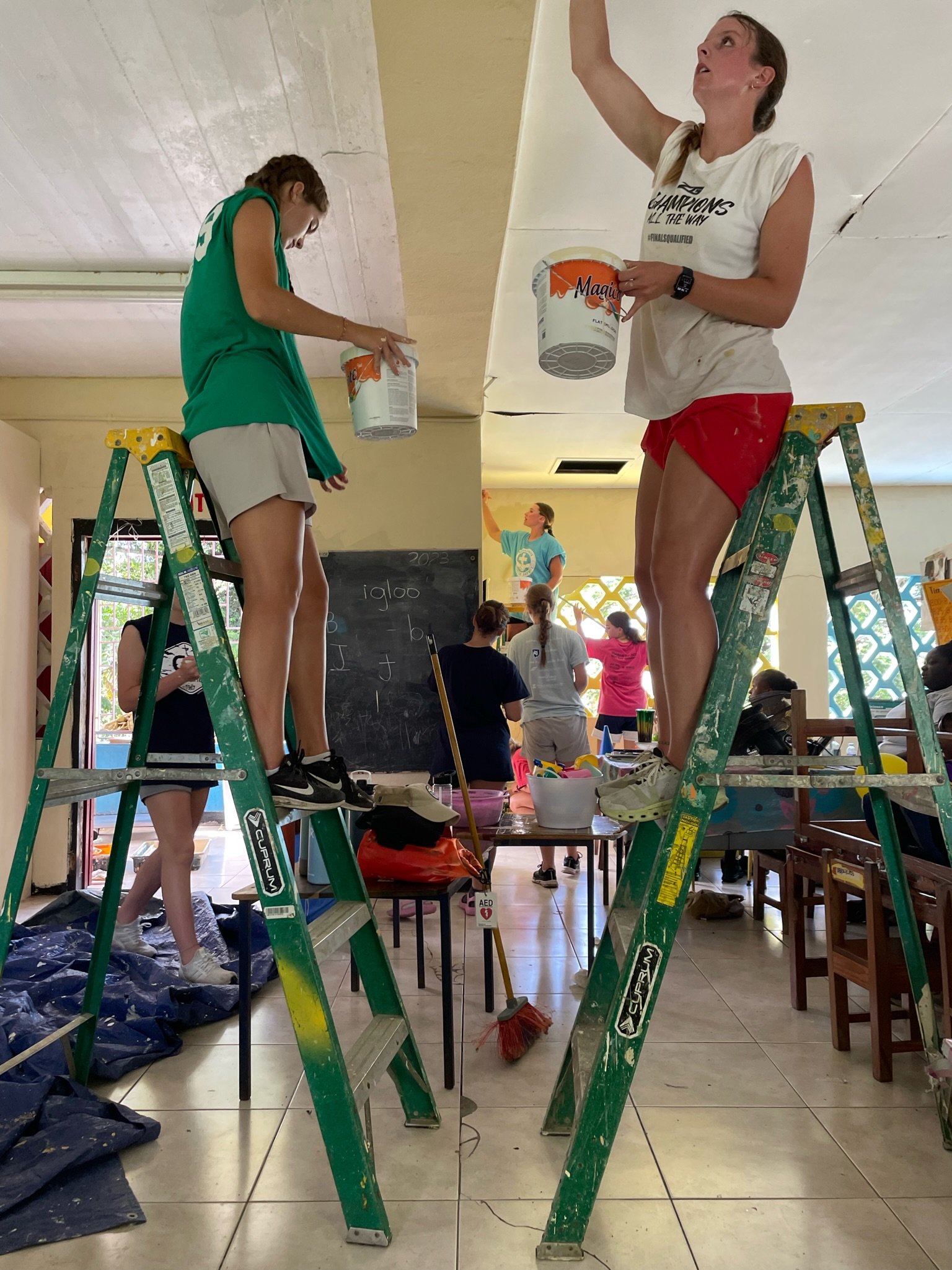 LM Varsity Girls Soccer Team in Jamaica painting classrooms