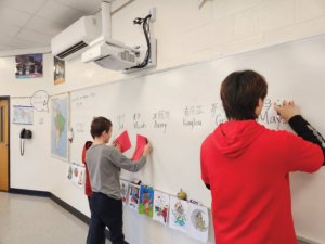 Students writing on board