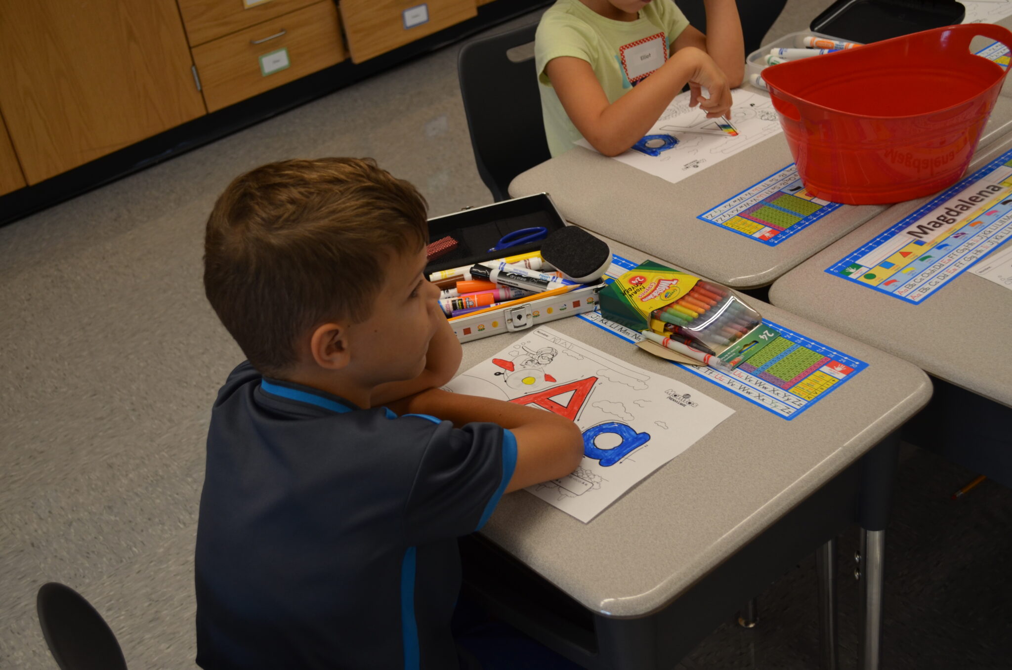 students practicing how to write the letter 