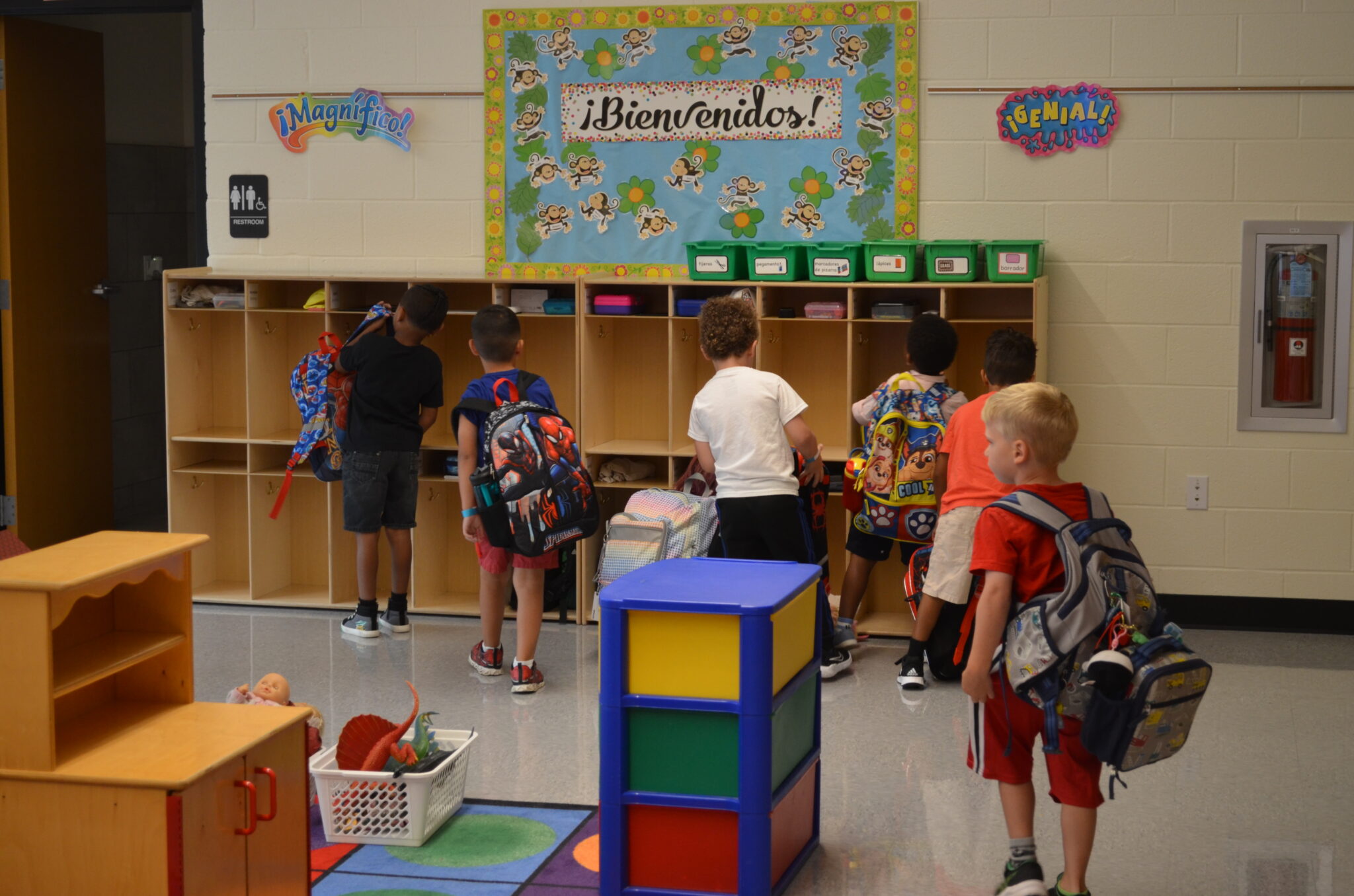 Students putting their backpacks in cubbies