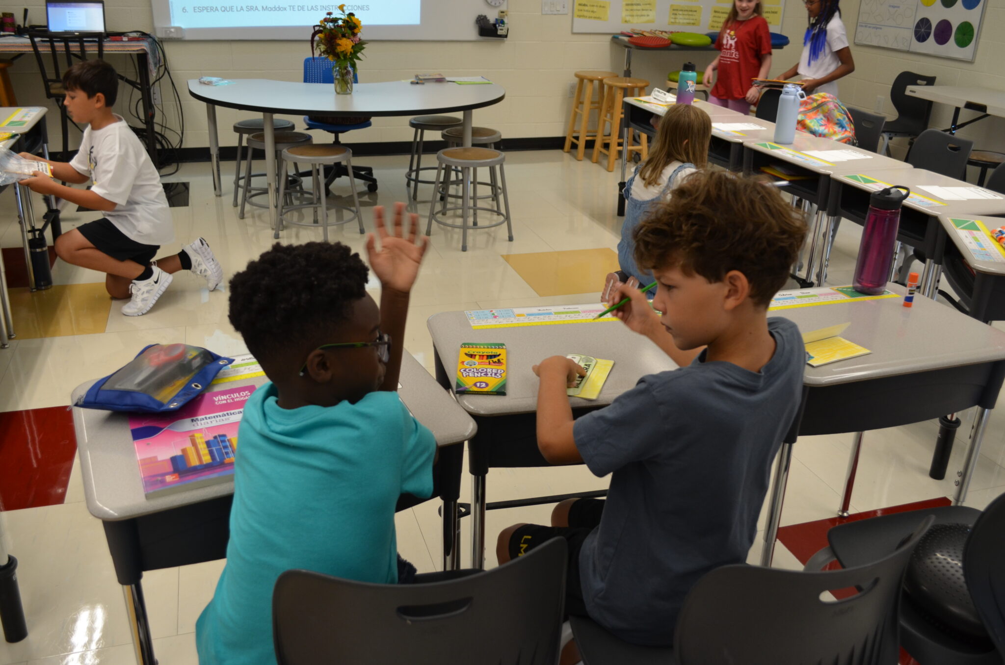 students at their desk talking