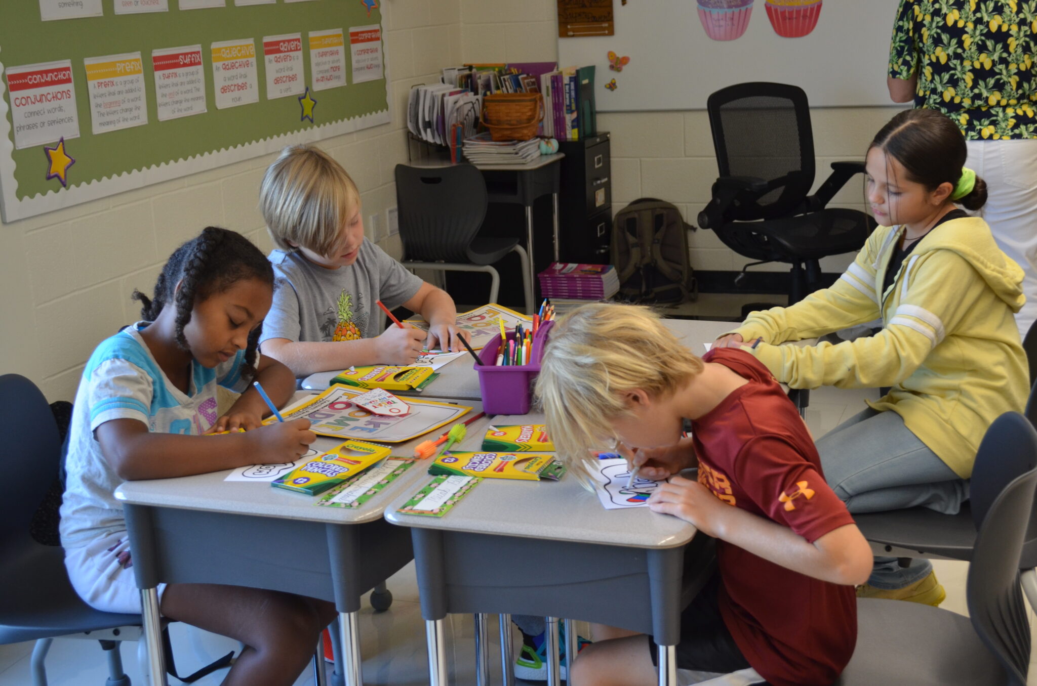 Students at their desks coloring