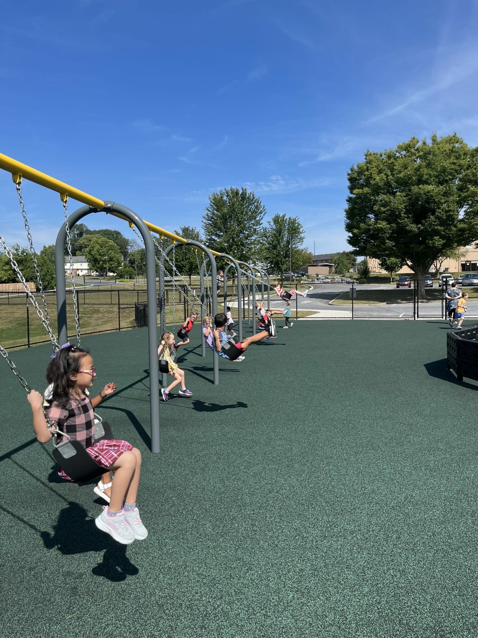 elementary students on the swings