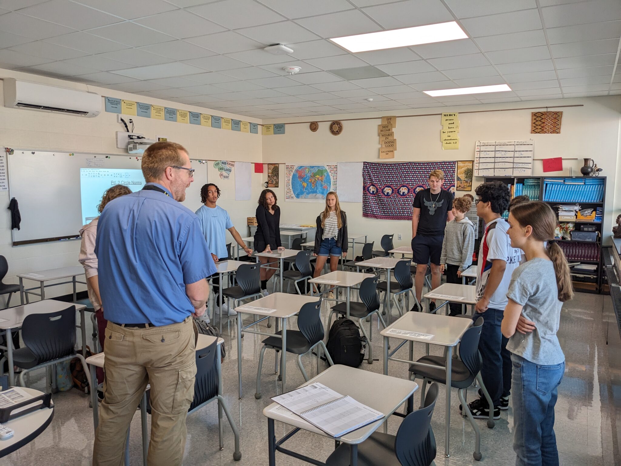students standing around desks