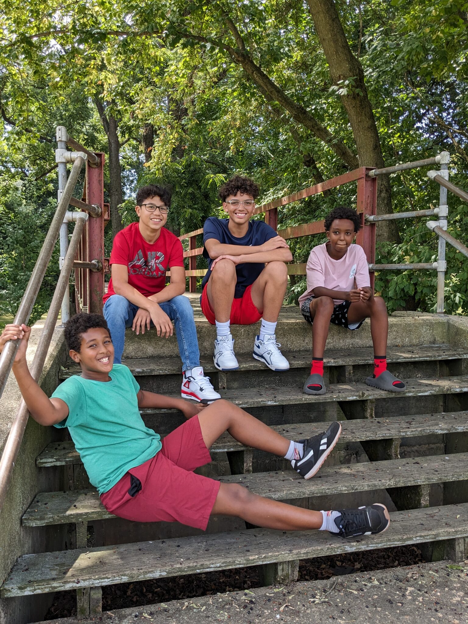 4 students sitting outside