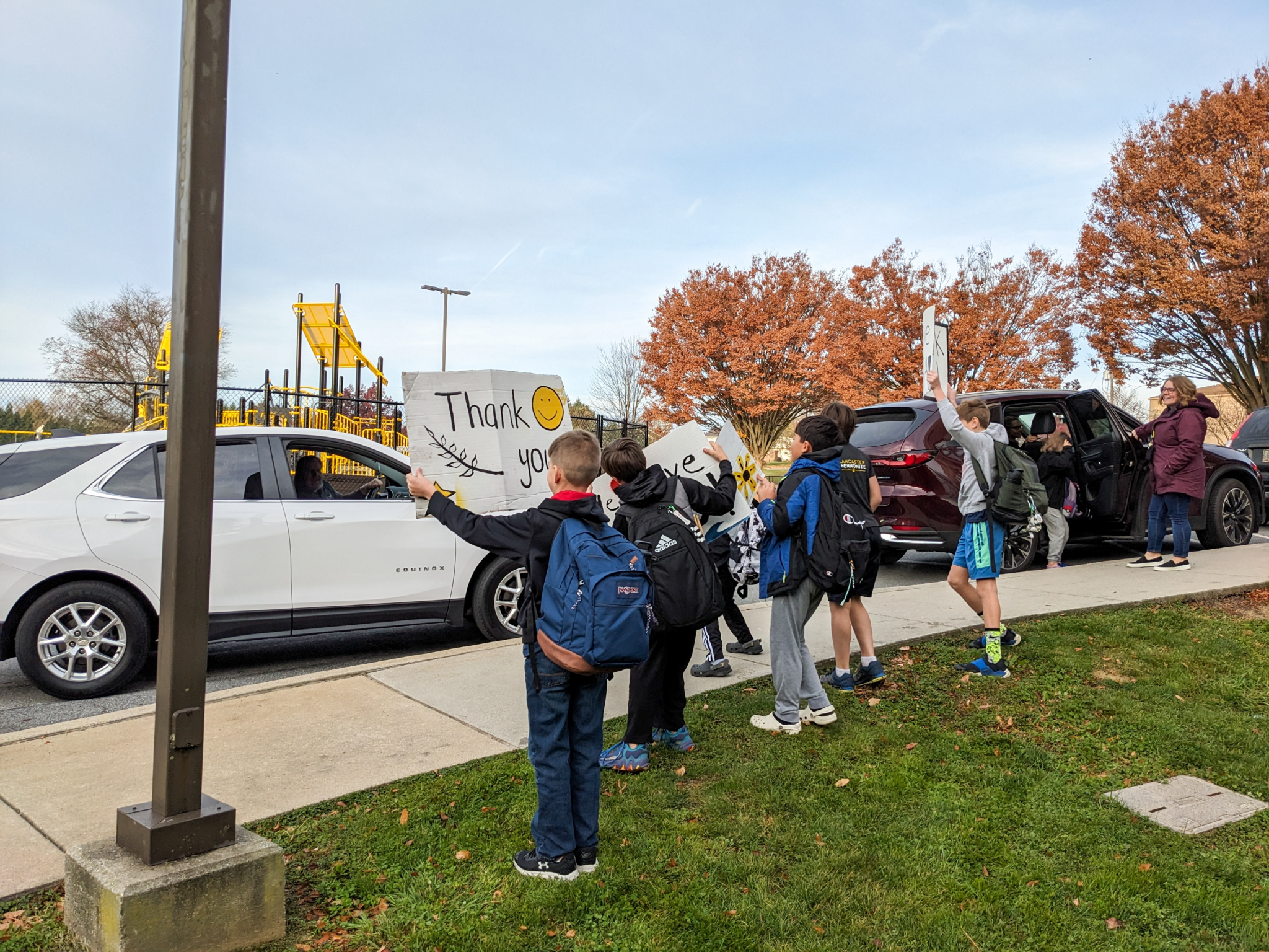 Elementary students holding up signs