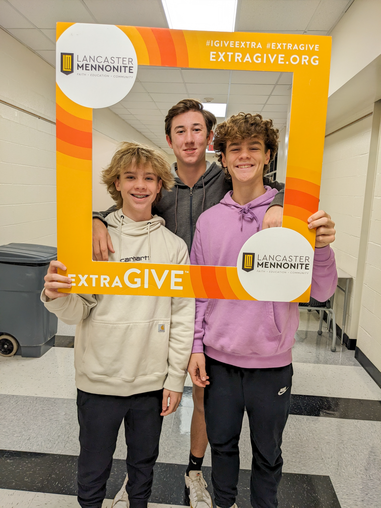 3 students in ExtraGive frame