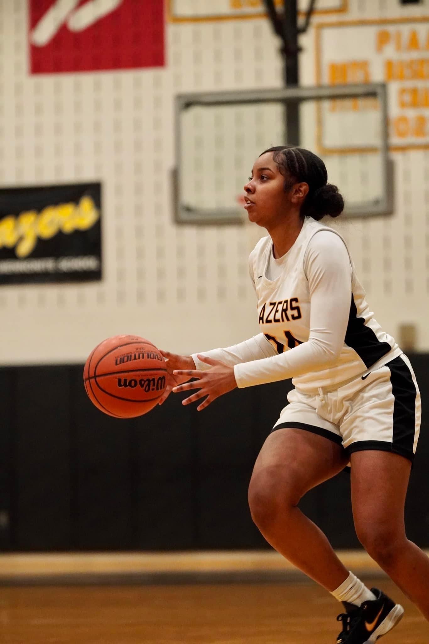student shooting the basketball