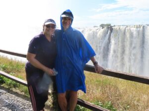 CHRIS AND HIS WIFE, MARLYS BOOK, ENJOYING THE MIST AND VIEW OF VICTORIA FALLS, ZAMBIA