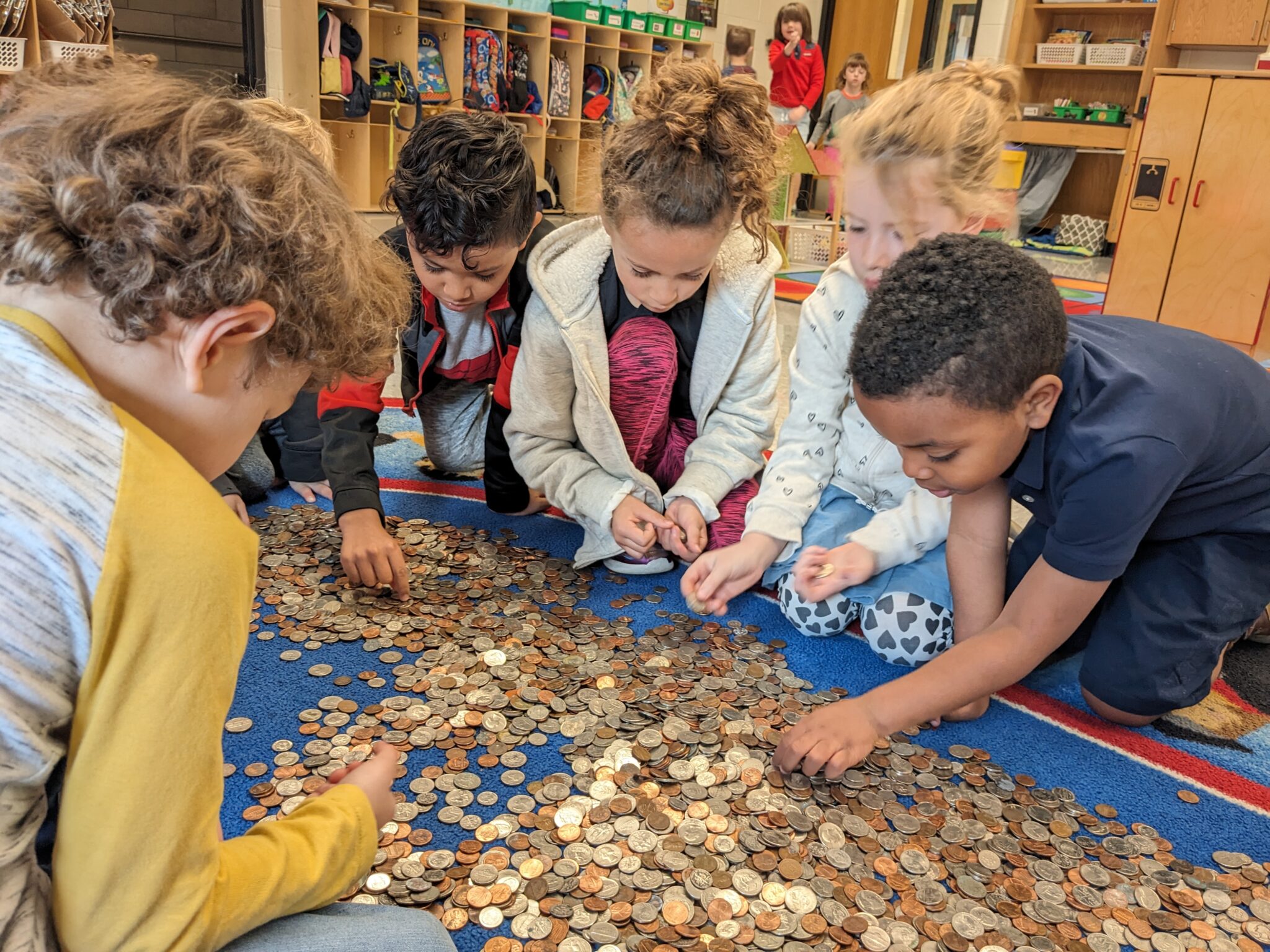 Elementary students counting coins