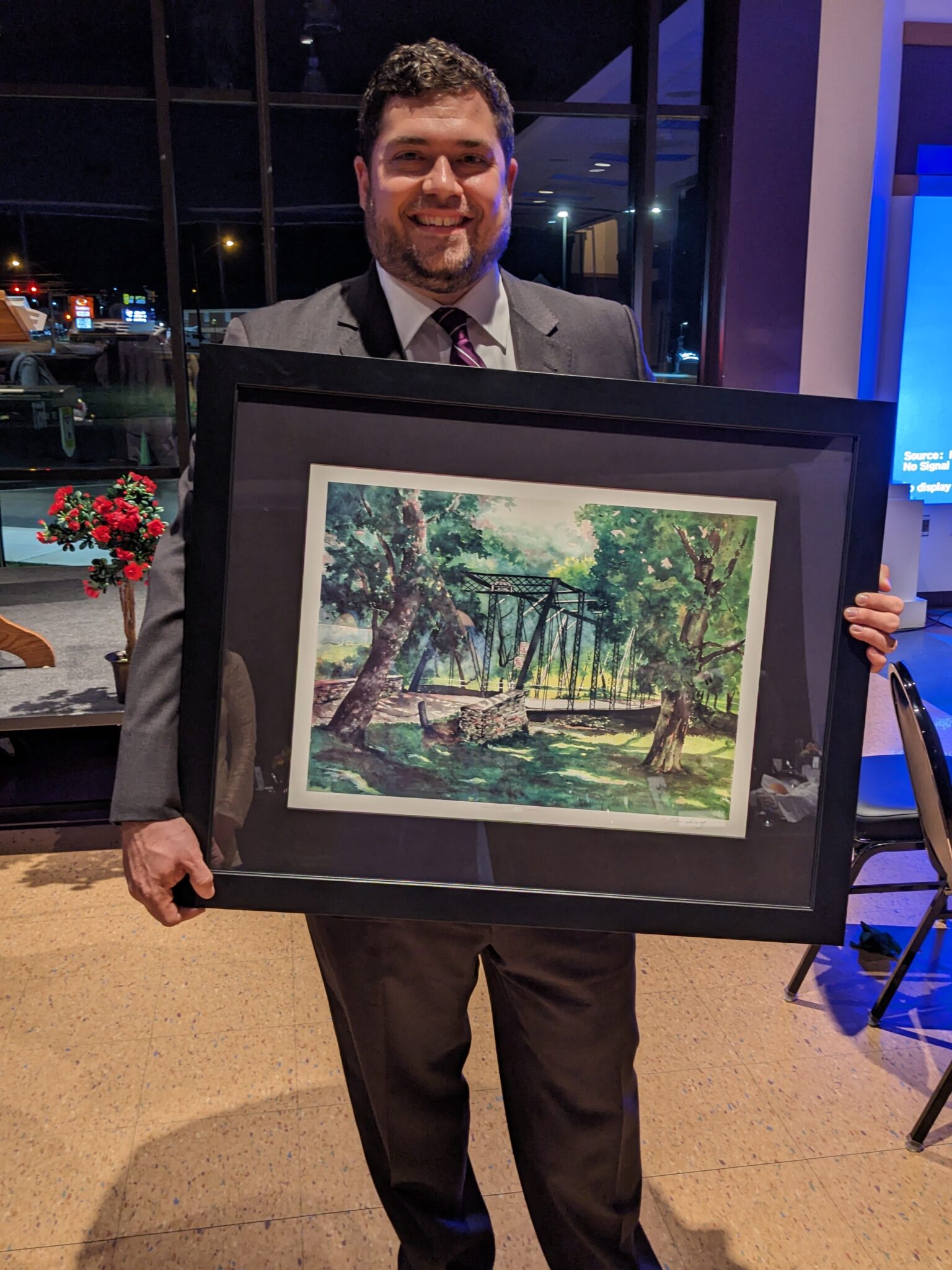 Ben Lesher holding picture of the Iron Bridge