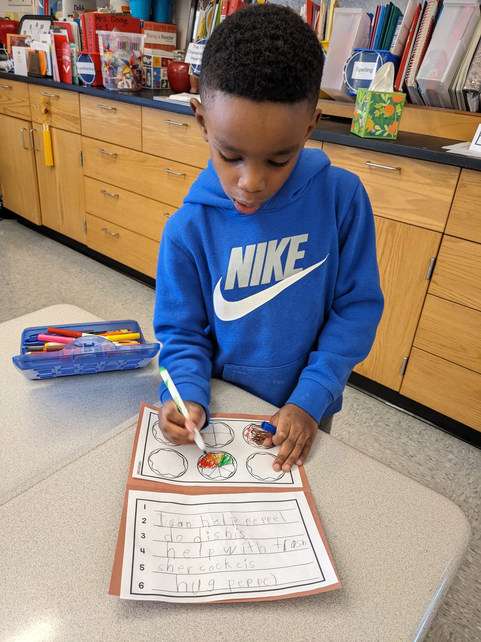 Elementary student creating Kindness Donuts.