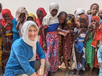 Photo Credit: MCC photo/Wawa Chege Rebecca Burkholder, MCC US Director of International Program, with school children who attend a school run by MCC partner, Association for the Promotion of Education (APE) in North Kanem, Chad.