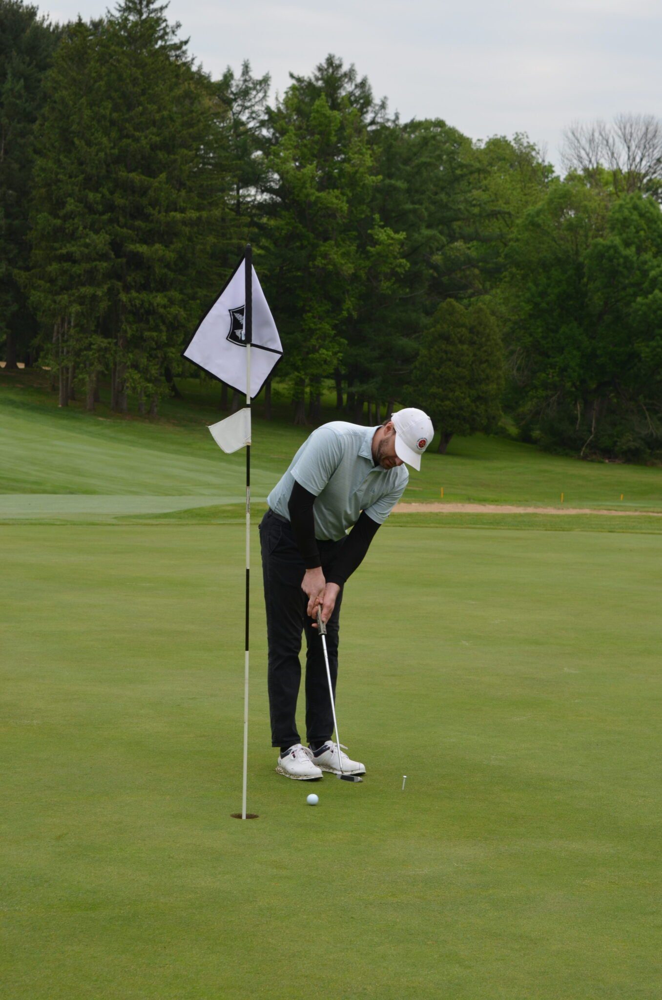 person hitting the golf ball