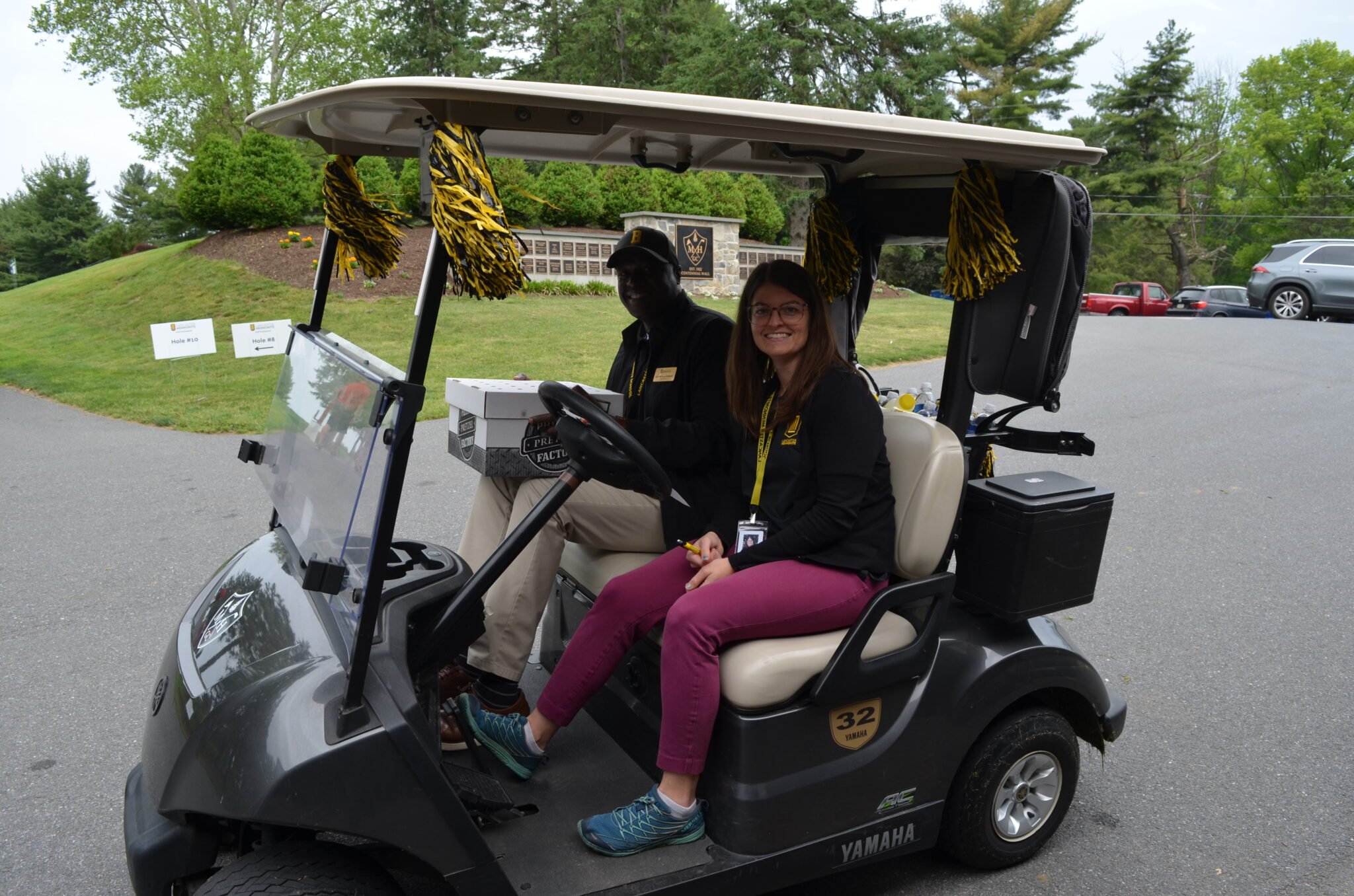 Kate and Dr. Badriaki in the golf cart