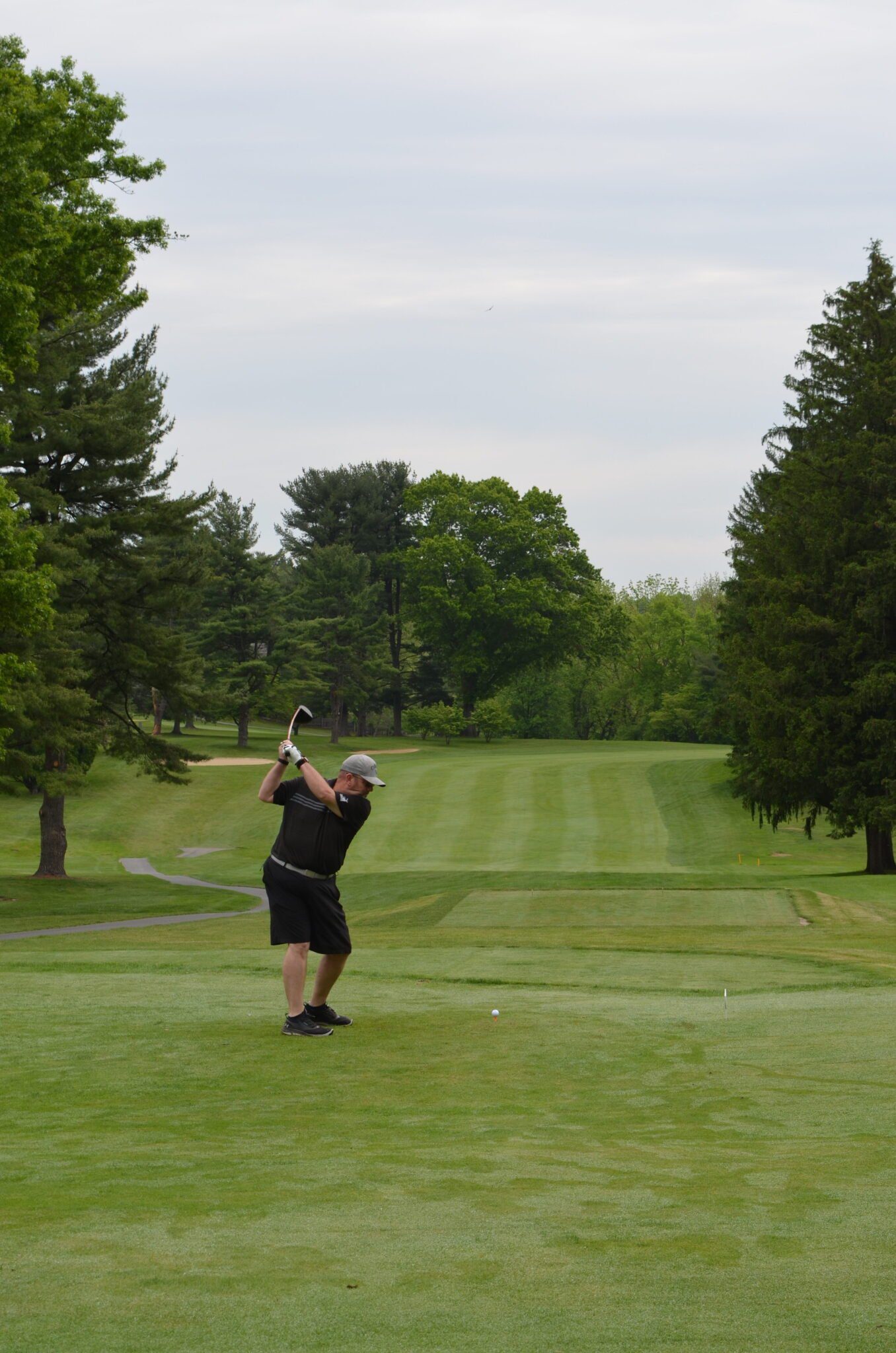 person swinging golf club